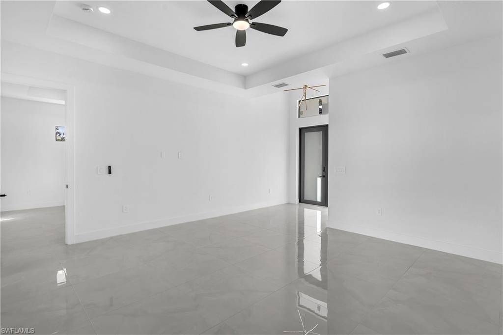 3110 23rd Street Southwest Lehigh Acres, FL 33976 - Photo 12 of 16 Unfurnished room featuring a raised ceiling, recessed lighting, and ceiling fan
