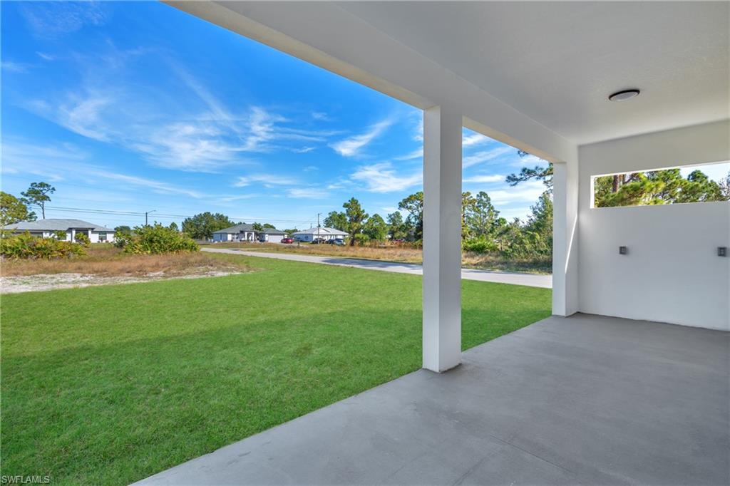 3110 23rd Street Southwest Lehigh Acres, FL 33976 - Photo 16 of 16 View of green lawn with a patio area