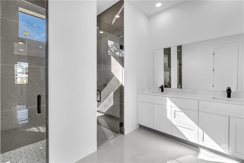 3110 23rd Street Southwest Lehigh Acres, FL 33976 - Photo 8 of 16 Full bathroom with a stall shower and double vanity