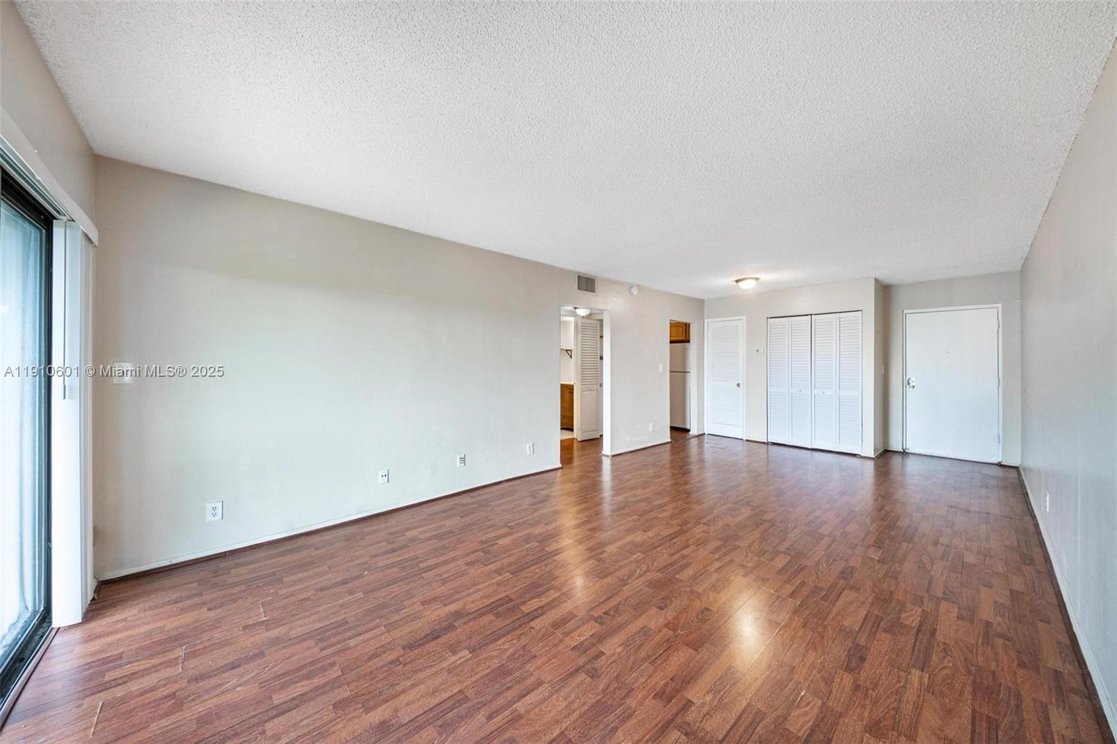 405 South Pine Island Road, Unit 405D Plantation, FL 33324 - Photo 17 of 28 a view of an empty room with wooden floor and a window