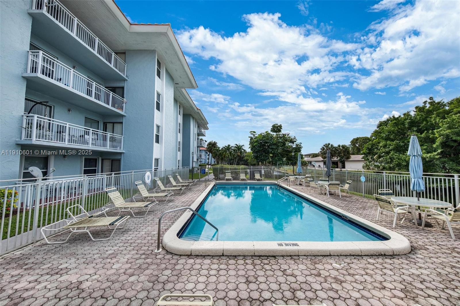 405 South Pine Island Road, Unit 405D Plantation, FL 33324 - Photo 22 of 28 a view of swimming pool with outdoor seating and plants