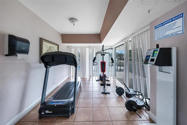 a room with gym equipment and a flat screen tv