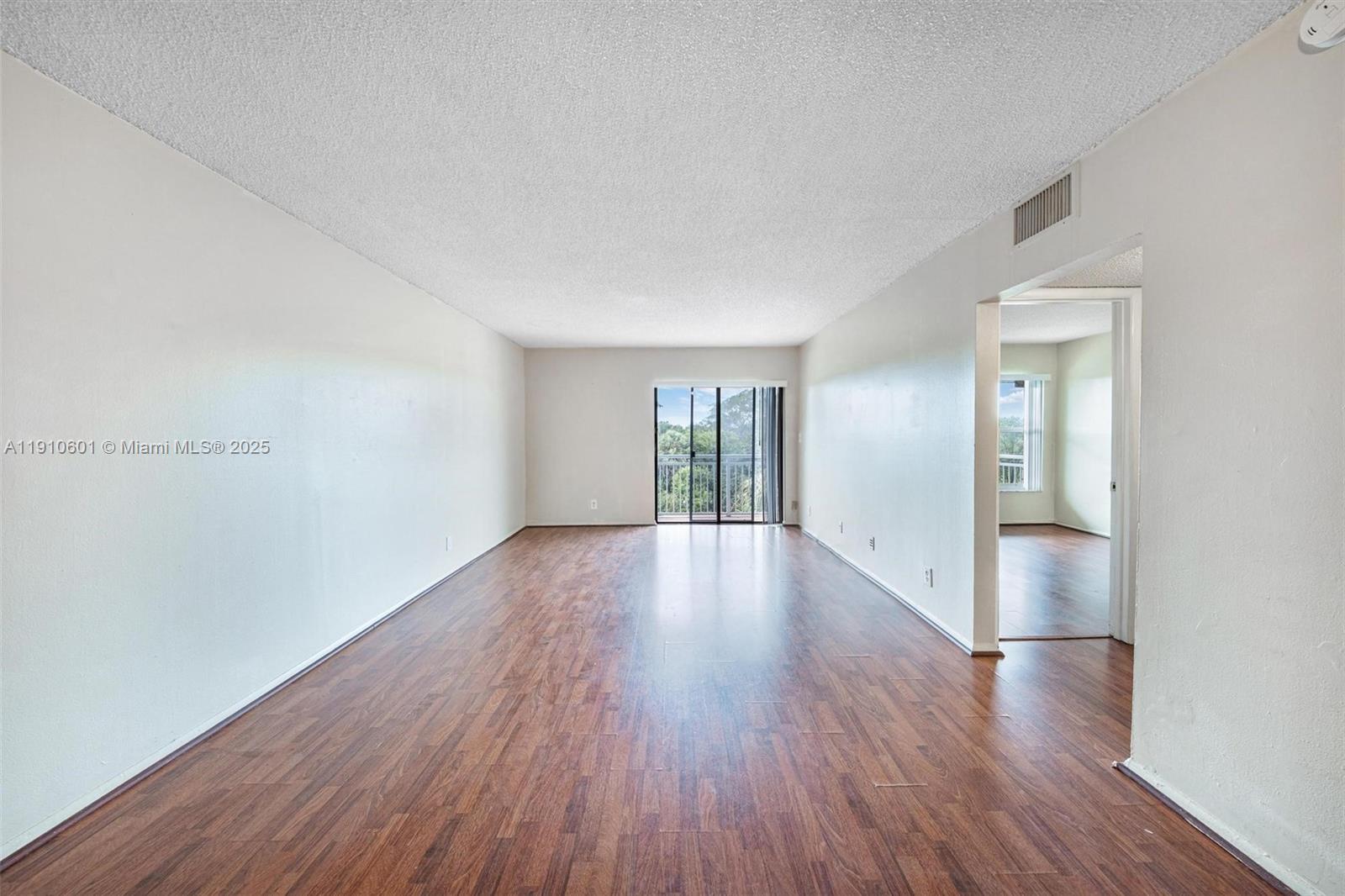 405 South Pine Island Road, Unit 405D Plantation, FL 33324 - Photo 6 of 28 an empty room with wooden floor and windows