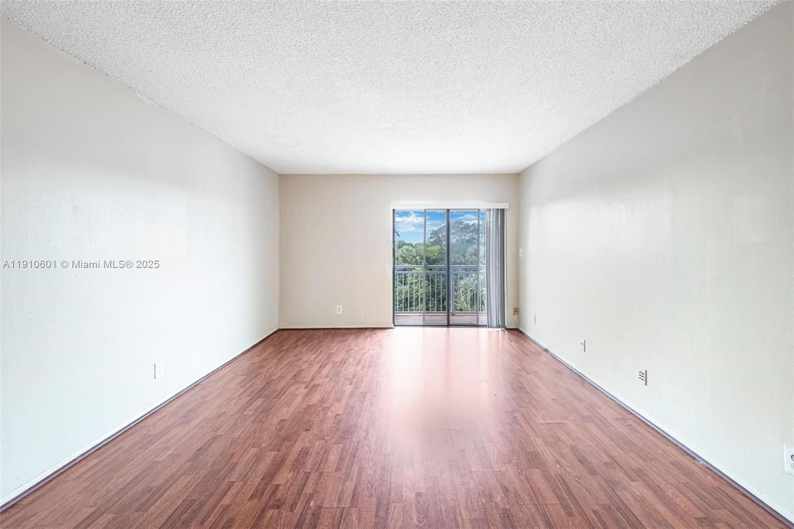 405 South Pine Island Road, Unit 405D Plantation, FL 33324 - Photo 7 of 28 an empty room with wooden floor and windows