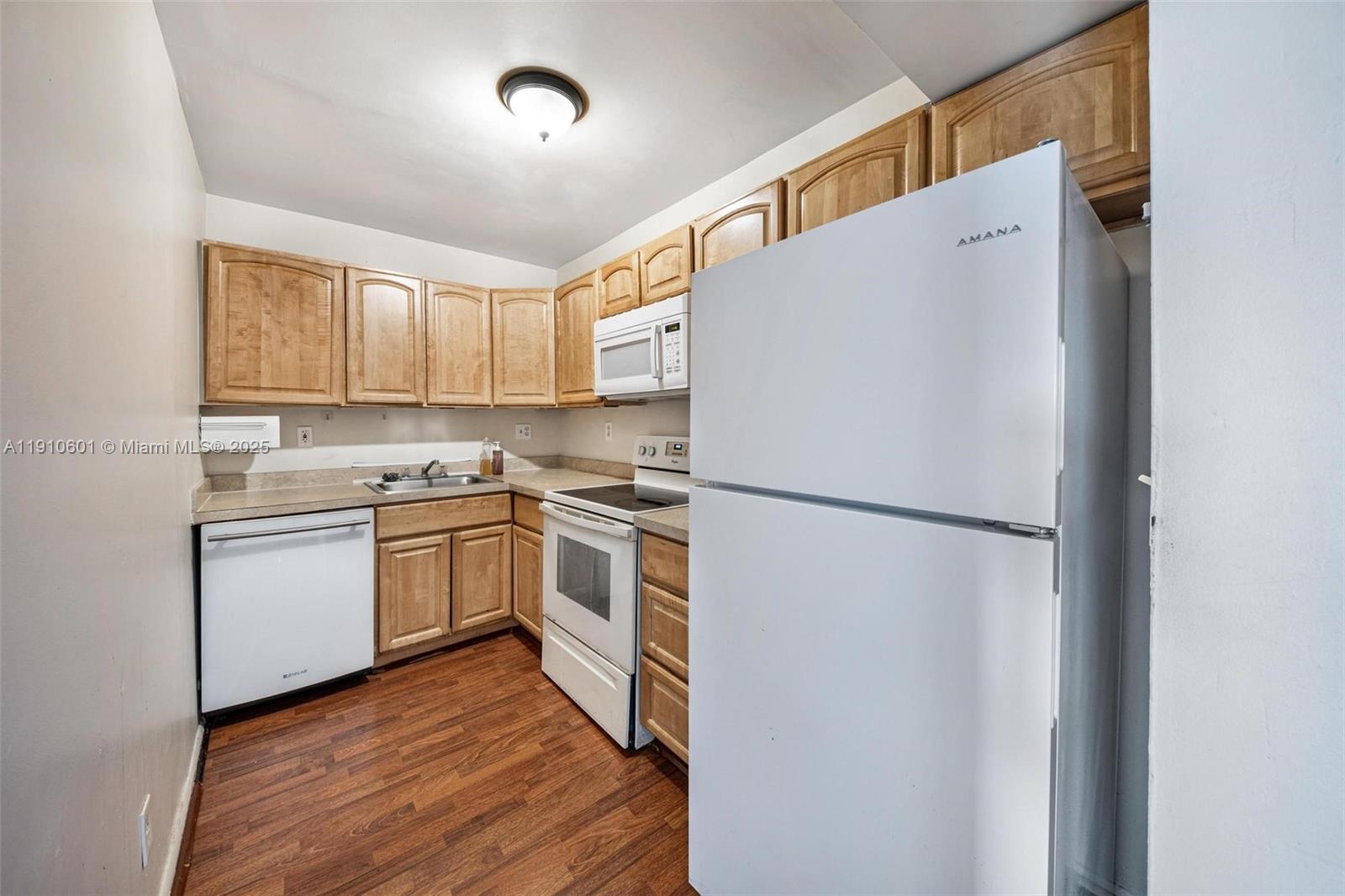 405 South Pine Island Road, Unit 405D Plantation, FL 33324 - Photo 10 of 28 a kitchen with a refrigerator sink stove and cabinets