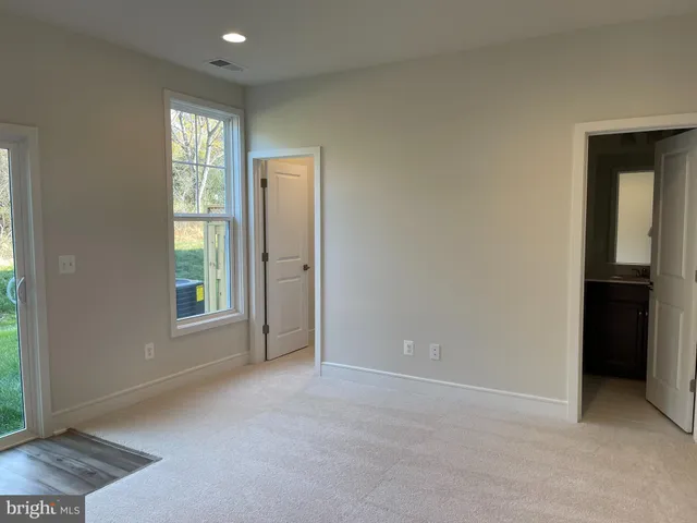 an empty room with windows and closet
