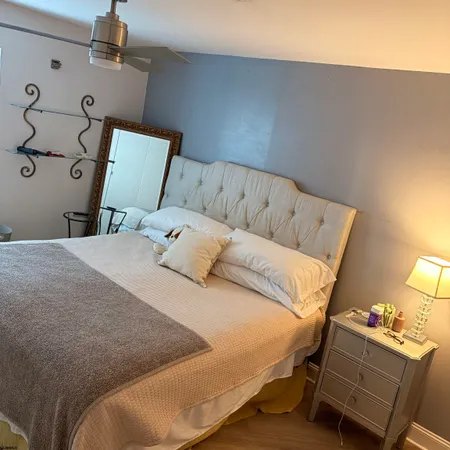 a bedroom with a bed and a lamp