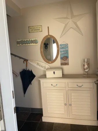 a living room with stainless steel appliances kitchen island granite countertop a rug a stove a microwave and a refrigerator