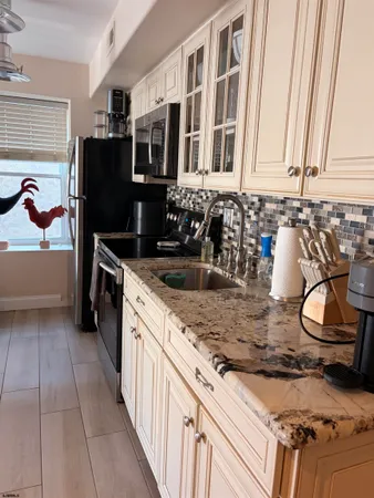 a kitchen with stainless steel appliances granite countertop a stove microwave and cabinets