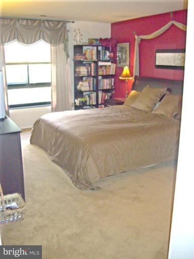 1808 Old Meadow Road, Unit 1405 McLean, VA 22102 - Photo 14 of 30 a bed sitting in a bedroom next to a window