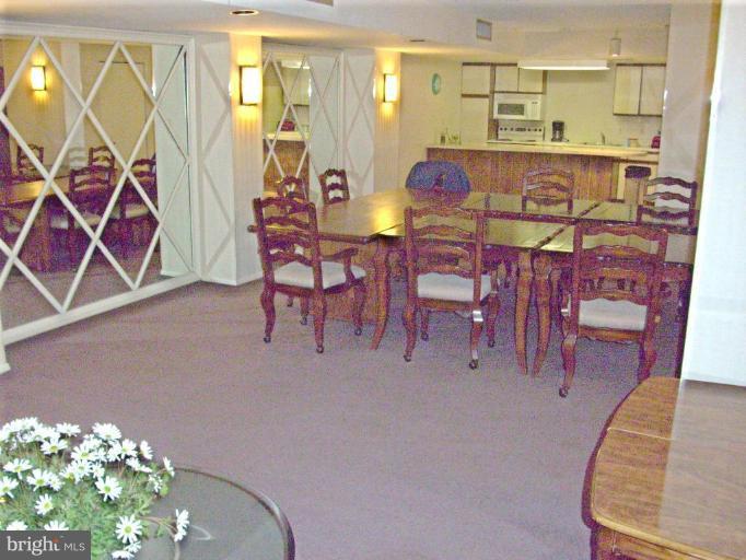 1808 Old Meadow Road, Unit 1405 McLean, VA 22102 - Photo 24 of 30 a view of a dining room with furniture and chandelier