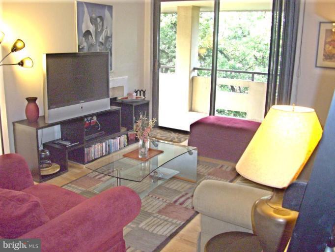 1808 Old Meadow Road, Unit 1405 McLean, VA 22102 - Photo 4 of 30 a living room with furniture and a flat screen tv