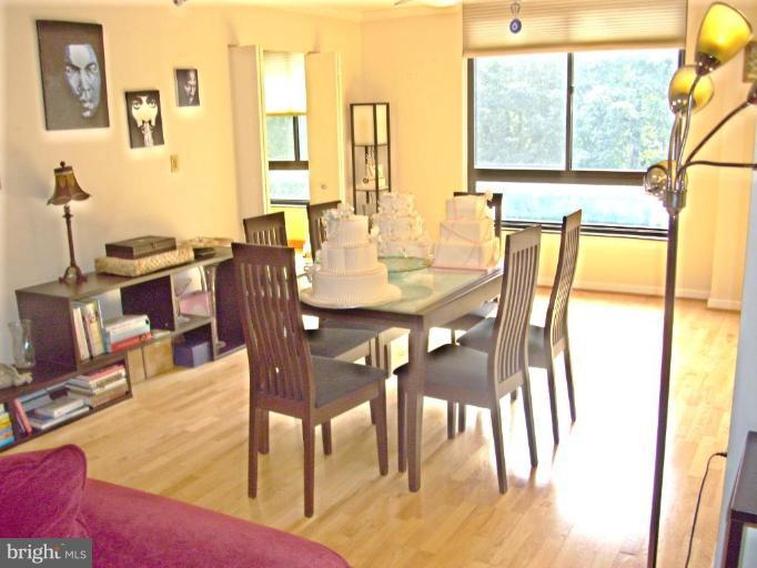 1808 Old Meadow Road, Unit 1405 McLean, VA 22102 - Photo 7 of 30 a view of a dining room with furniture and a large window
