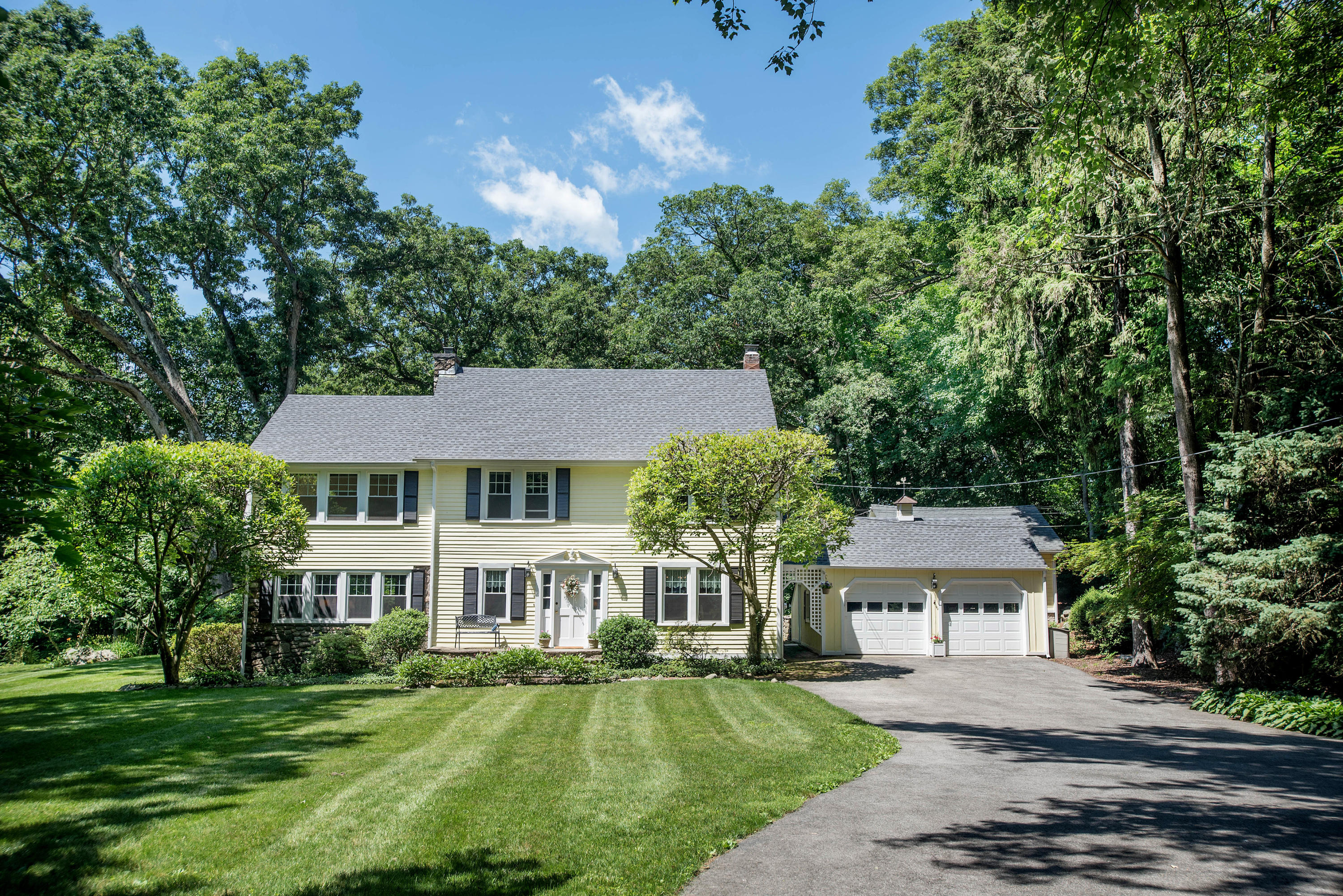 a front view of a house with a garden