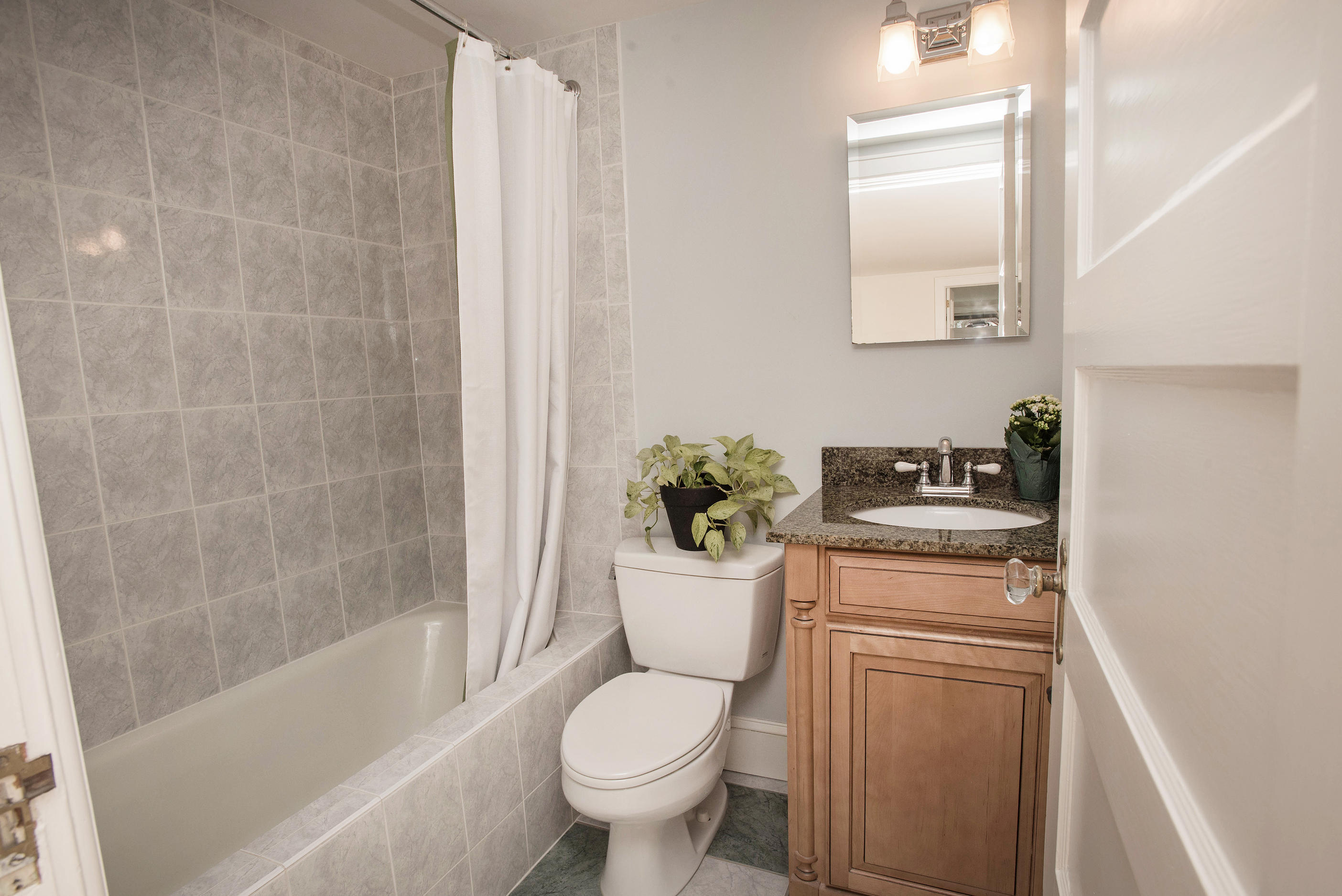 43 Marvin Ridge Road New Canaan, CT 06840 - Photo 38 of 41 a bathroom with a granite countertop toilet a sink and a bathtub