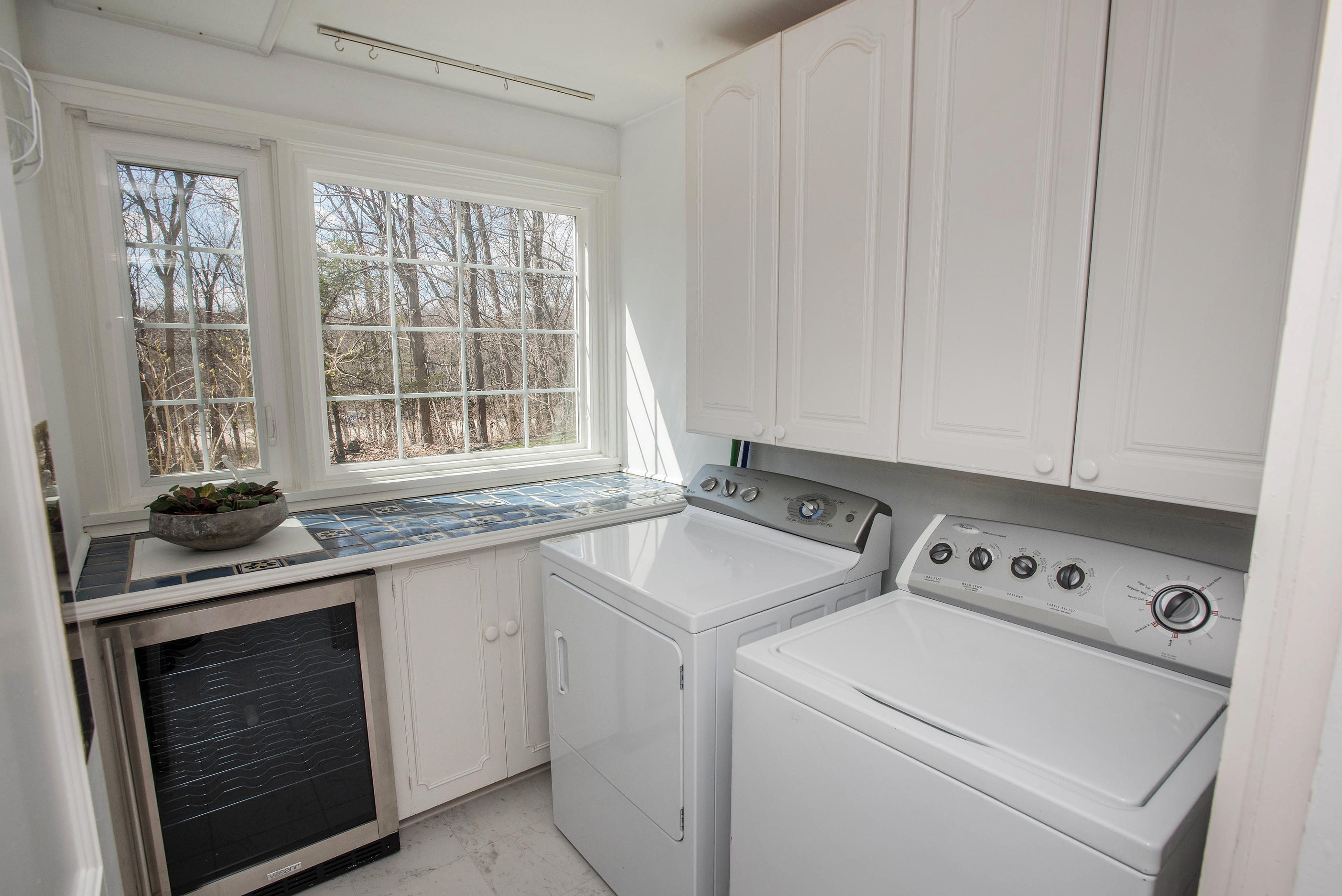 43 Marvin Ridge Road New Canaan, CT 06840 - Photo 40 of 41 a view of washer and dryer with white cabinets
