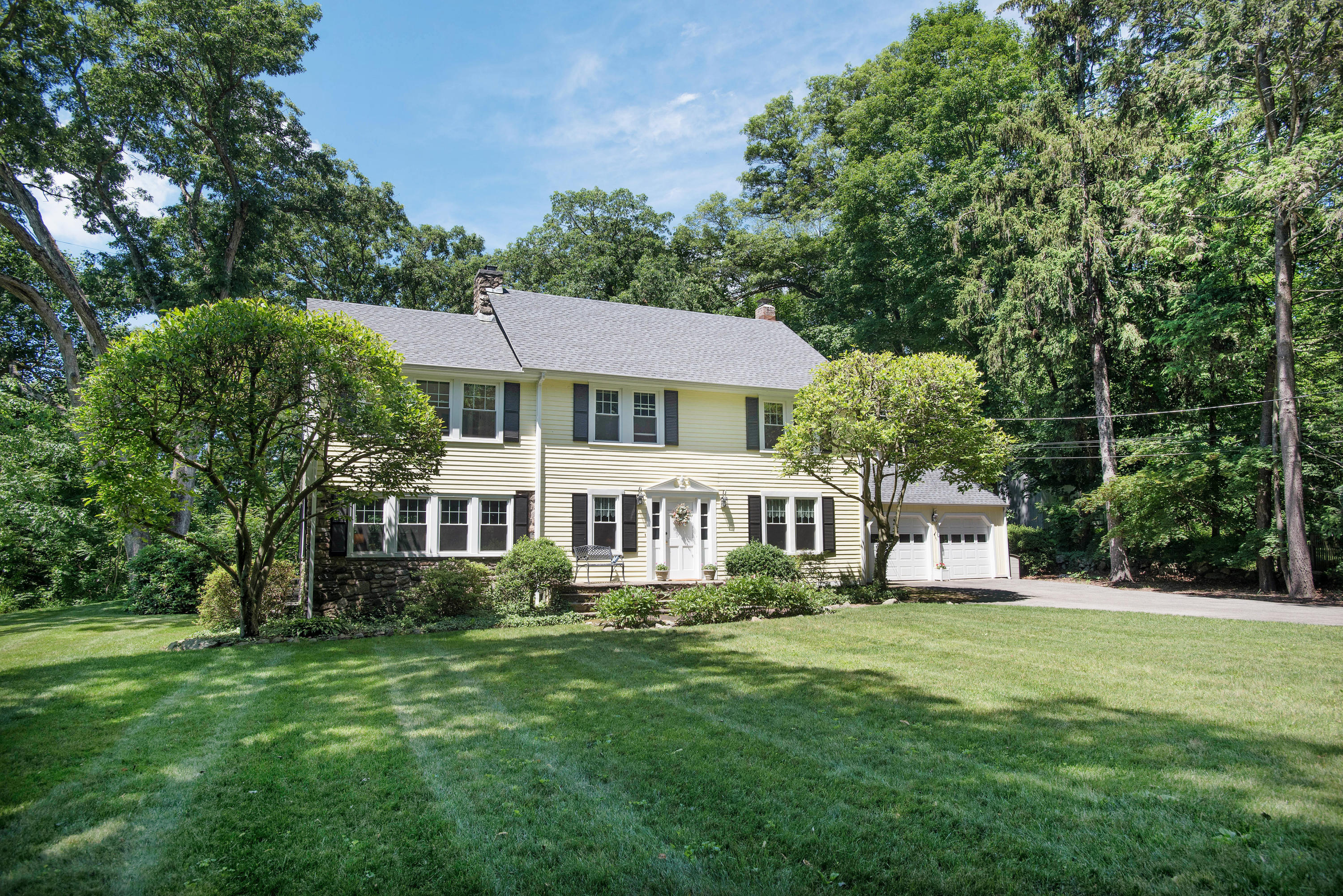 43 Marvin Ridge Road New Canaan, CT 06840 - Photo 41 of 41 a front view of a house with a yard table and chairs