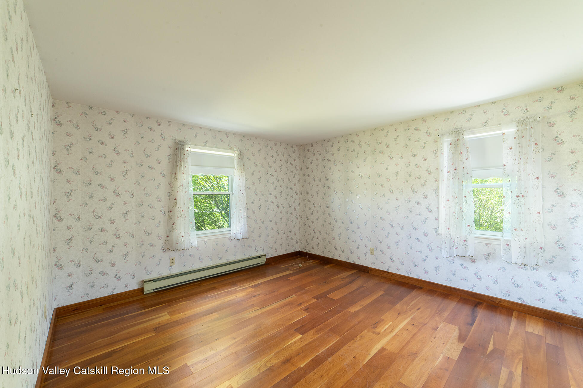 317 Mountain View Road Copake, NY 12516 - Photo 14 of 27 an empty room with wooden floor and windows