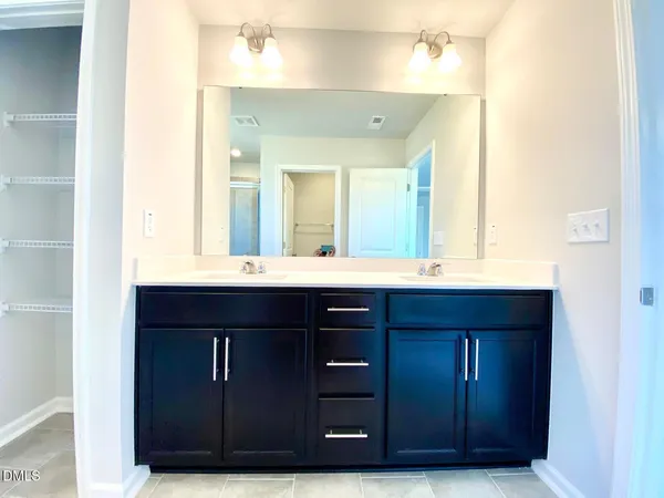 a bathroom with a sink vanity and mirror