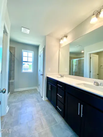 a spacious bathroom with a sink mirror and a bath tub