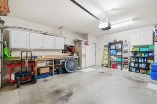 a bedroom with a bed a dresser and flat screen tv