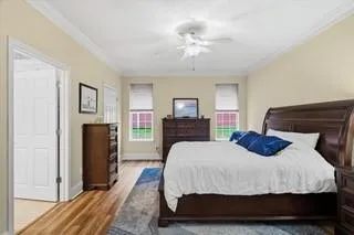 a bedroom with a large bed and a chandelier