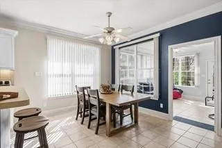 a kitchen with stainless steel appliances granite countertop a table chairs sink refrigerator and cabinets