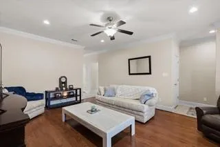 a living room with furniture and wooden floor