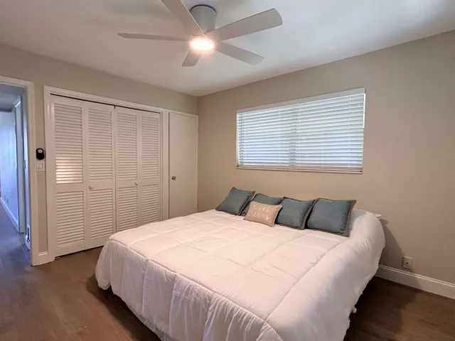 a bedroom with a large bed and a ceiling fan
