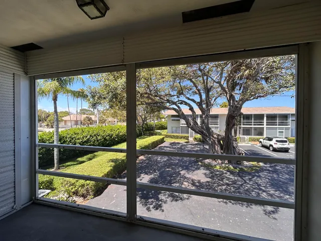 a view of a cars park in front of a building