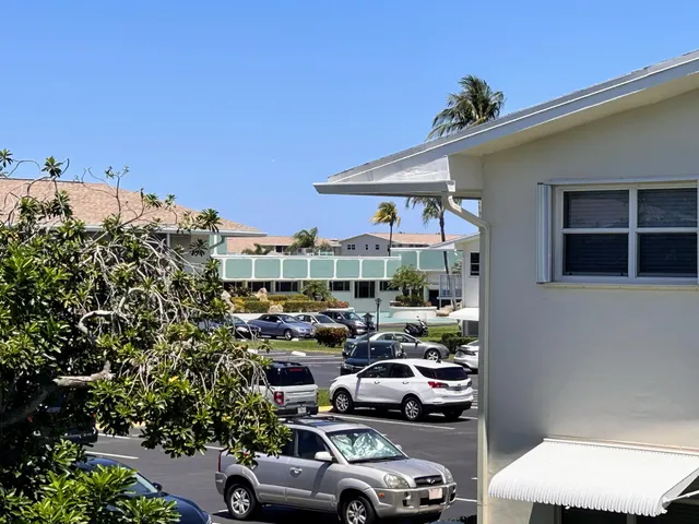 a utility room with dryer washer and a view of living room