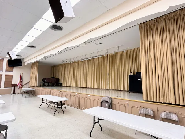 a living room with furniture and a book shelf
