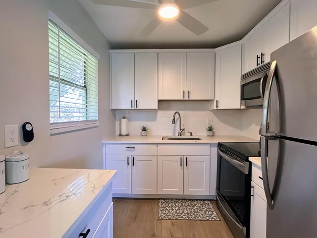 a kitchen with sink cabinets and window