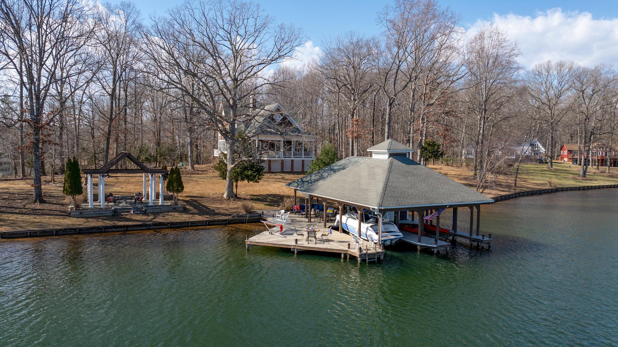 a view of swimming pool with outdoor seating and lake view