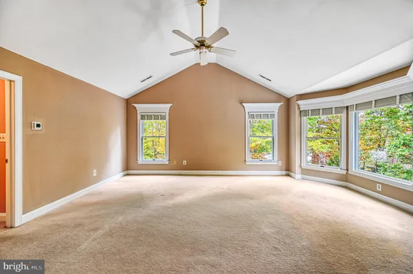 a view of a balcony with chairs and wooden fence