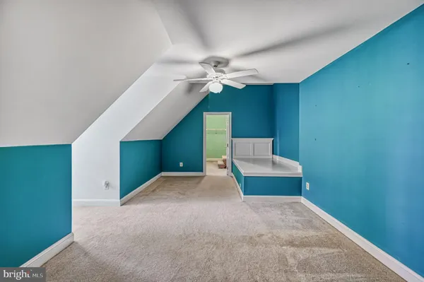 a front view of a house with a garden and trees