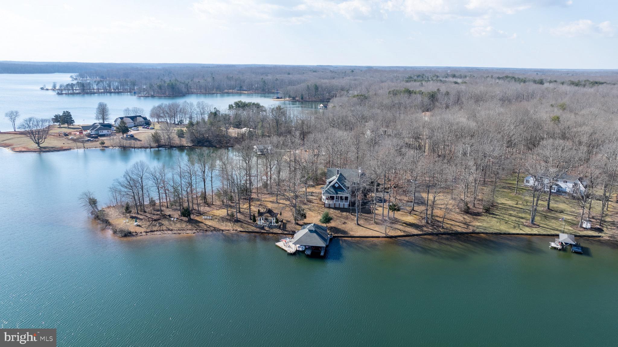 175 Covenant Way Bumpass, VA 23024 - Photo 51 of 140 a view of a lake with boats and trees in the background