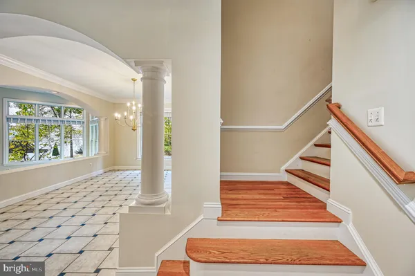 a view of empty room with fan fireplace and a large window