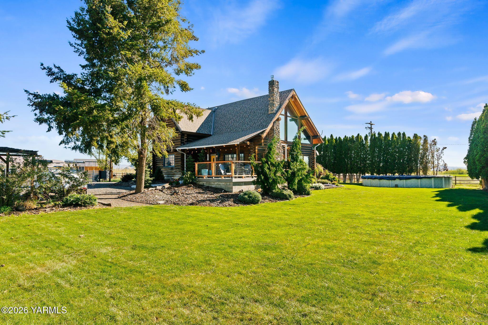 2550 Kays Road Wapato, WA 98951 - Photo 2 of 52 a view of swimming pool with outdoor seating and a garden