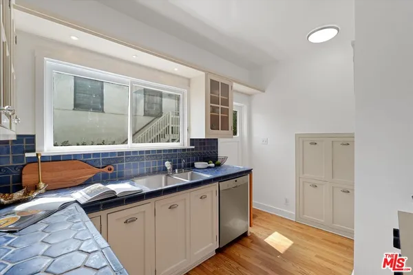 a kitchen with granite countertop a sink and a stove