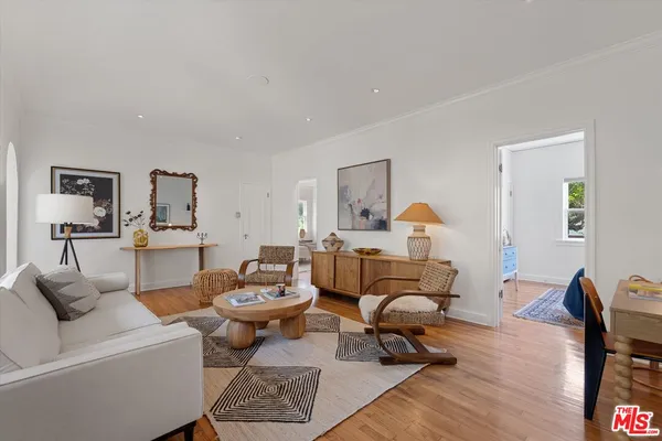 a living room with furniture a rug and a lamp