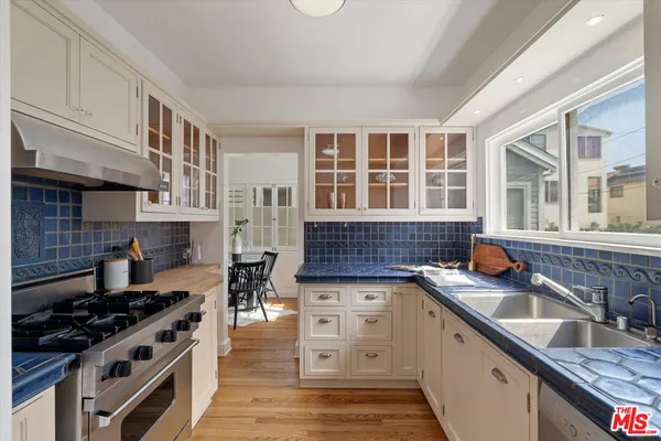a kitchen with stainless steel appliances granite countertop a stove and a sink