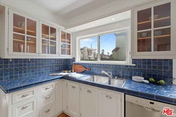 a kitchen with stainless steel appliances a sink and cabinets