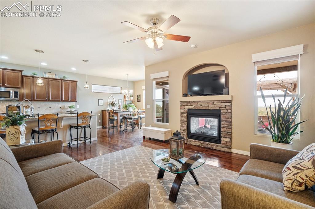 11501 Palmers Green Drive Peyton, CO 80831 - Photo 19 of 49 a living room with furniture and a fireplace