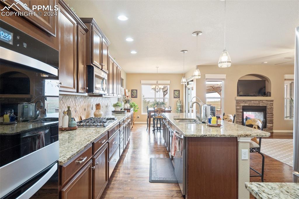 11501 Palmers Green Drive Peyton, CO 80831 - Photo 23 of 49 a kitchen with lots of counter top space a sink and appliances
