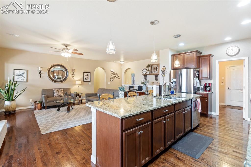 11501 Palmers Green Drive Peyton, CO 80831 - Photo 27 of 49 a large kitchen with stainless steel appliances granite countertop a lot of counter space and a sink
