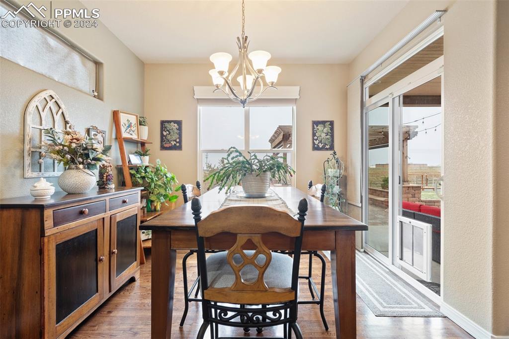 11501 Palmers Green Drive Peyton, CO 80831 - Photo 28 of 49 a dining room with furniture a livingroom and chandelier