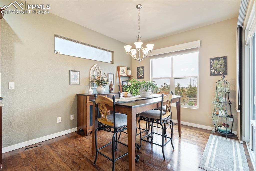 11501 Palmers Green Drive Peyton, CO 80831 - Photo 29 of 49 a view of a dining room with furniture window and wooden floor