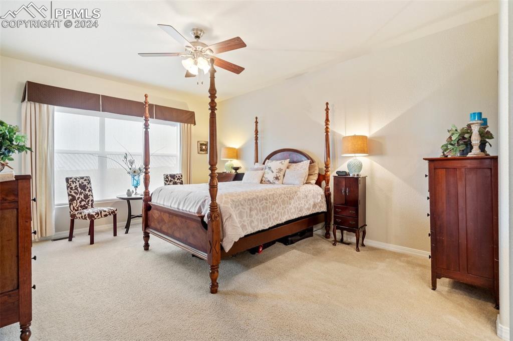 11501 Palmers Green Drive Peyton, CO 80831 - Photo 30 of 49 a bedroom with a bed chandelier and a window