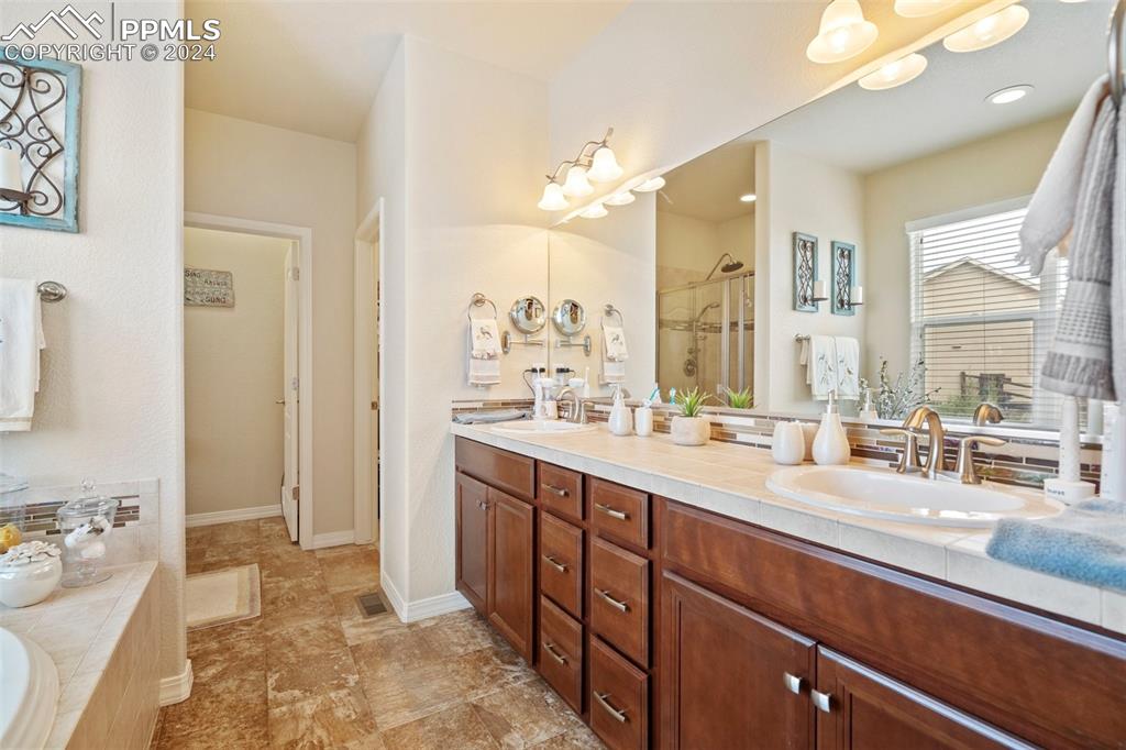 11501 Palmers Green Drive Peyton, CO 80831 - Photo 32 of 49 a spacious bathroom with a sink double vanity and a mirror